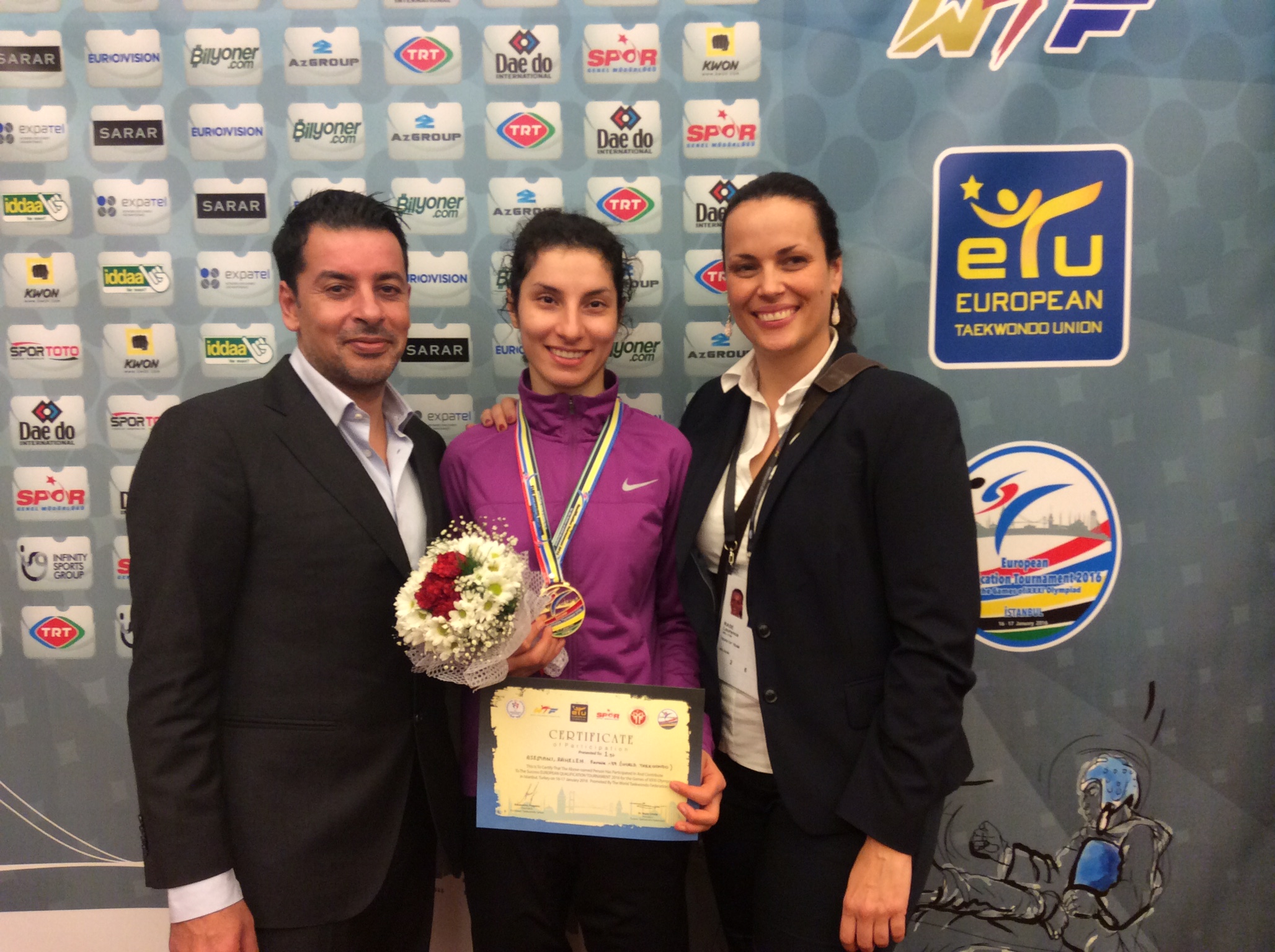 Asemani celebrates with her coach Karim Dighou (left) and performance Director Laurence Rase (right)