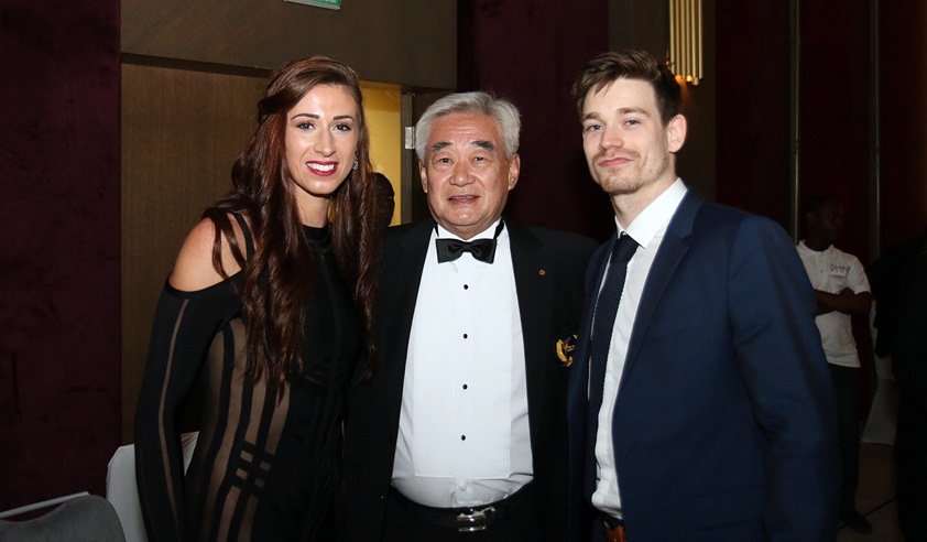 Biancan Walkden and Aaron Cook with WT President Chungwon Choue (center) during the Gala Awards