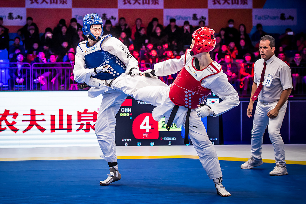 Yushuai LIANG (CHN, right) is attacking opponent at the semi-final match of M -58kg